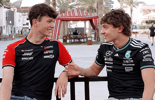 Two Men Wearing UBS Shirts Talking GIF