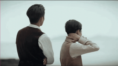 Two Men With Arms Crossed Looking At Ocean GIF