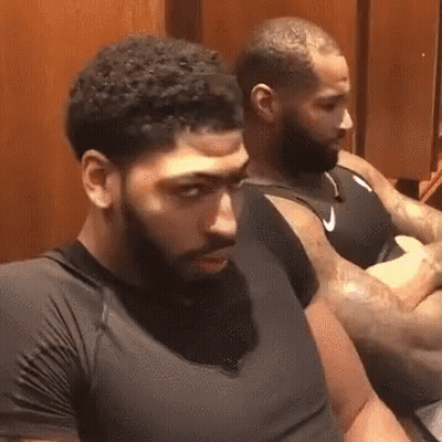 Two Men With Beards Are Sitting In A Locker Room . GIF
