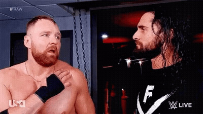 Two Men With Beards Are Standing Next To Each Other In A Room . GIF