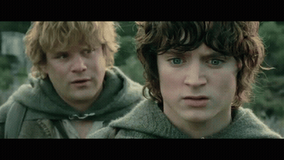 Two Men With Curly Hair Are Standing Next To Each Other And Looking At Each Other . GIF