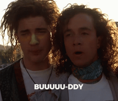 Two Men With Curly Hair Are Standing Next To Each Other And One Of Them Is Saying Buuuu-Ddy GIF