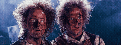 Two Men With Dirty Faces In Dark Room GIF