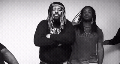 Two Men With Dreadlocks Standing With Arms Crossed GIF