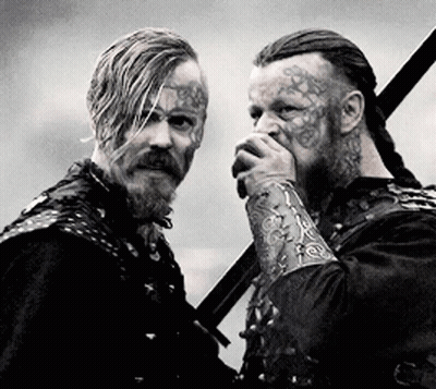 Two Men With Face Tattoos Holding Swords GIF