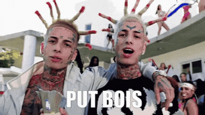 Two Men With Face Tattoos One Wearing Put B Shirt GIF