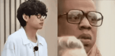 Two Men With Glasses, One In Scarf GIF