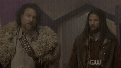 Two Men With Long Hair And Beard In Dark Room GIF