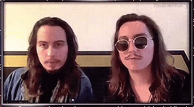 Two Men With Long Hair And Mustaches In Sunglasses GIF