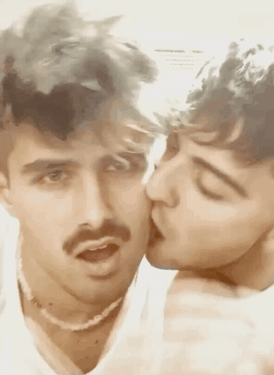 Two Men With Mustaches Kissing GIF