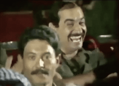 Two Men With Mustaches Laughing In Theater GIF
