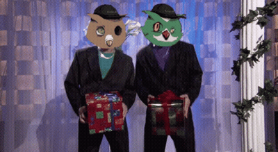 Two Men With Owl Masks Holding Presents GIF