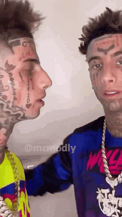Two Men With Tattooed Faces Looking At Each Other GIF