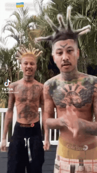 Two Men With Tattoos And Dreadlocks By Palm Tree GIF
