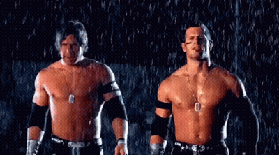 Two Men Without Shirts Are Standing In The Rain . GIF