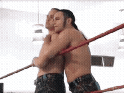 Two Men Wrestling And Hugging GIF