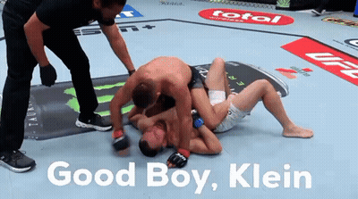 Two Men Wrestling In A Boxing Ring With The Words Good Boy Klein On The Bottom GIF