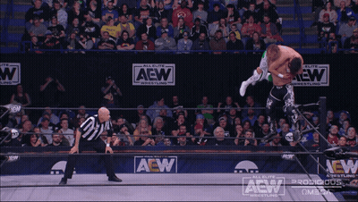 Two Men Wrestling In A Ring On Saturday May 18 GIF