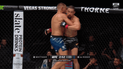 Two Men Wrestling In Boxing Ring With Crypto.com Banner GIF