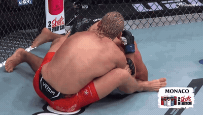 Two Men Wrestling In Front Of 2 Shots Sign GIF