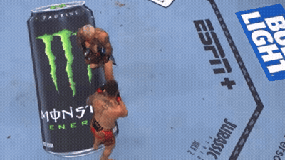 Two Men Wrestling In Front Of Monster Energy Can GIF