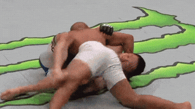 Two Men Wrestling In Front Of Monster Energy Sign GIF
