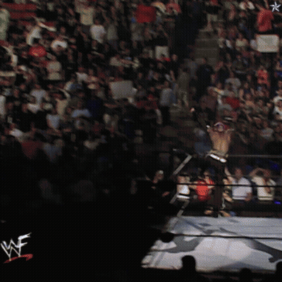 Two Men Wrestling In Front Of Screen With Star GIF
