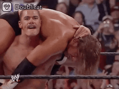 Two Men Wrestling In Ring Holding Head GIF