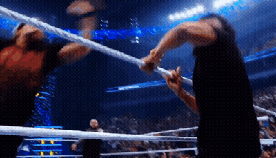 Two Men Wrestling In Ring One Holding Rope GIF