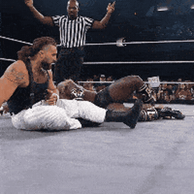Two Men Wrestling In Ring, One On Floor GIF