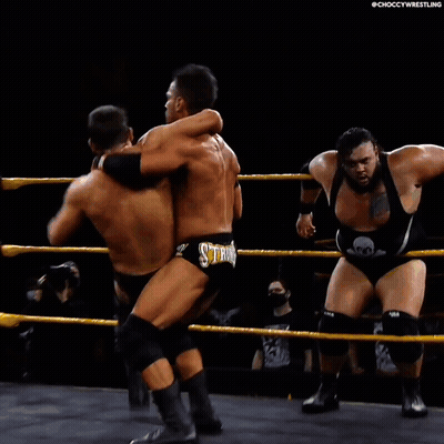 Two Men Wrestling In Ring One Wearing Reigns Short GIF