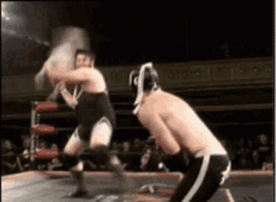 Two Men Wrestling In Ring One With Helmet GIF