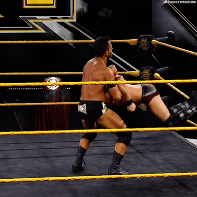 Two Men Wrestling In Ring Saying NX GIF