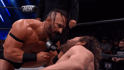 Two Men Wrestling In Ring With AEW Microphone GIF