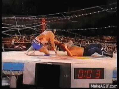 Two Men Wrestling In Ring With Digital Clock GIF