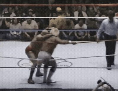 Two Men Wrestling In Ring With Referee GIF