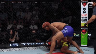 Two Men Wrestling In Ring With Sign 2 Shots In Every Can GIF