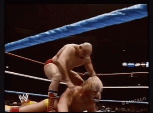 Two Men Wrestling One Holding Other's Head GIF