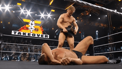 Two Men Wrestling With Takeover Sign GIF