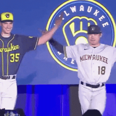 Two Milwaukee Baseball Players Next To Logo GIF
