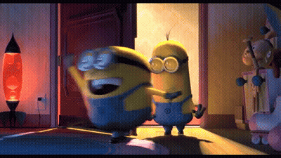 Two Minions Are Hugging Each Other In A Room With A Lamp In The Background GIF