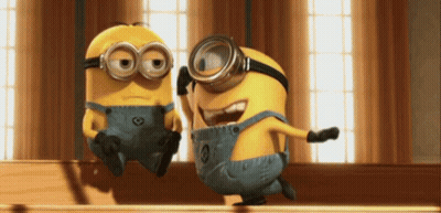 Two Minions In Goggles And Overalls Together GIF