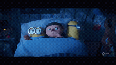 Two Minions Lying In Bed With Goggles GIF