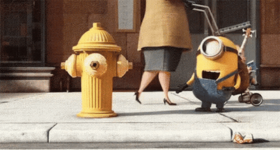 Two Minions Standing Next To Yellow Fire Hydrant GIF