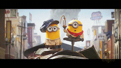 Two Minions Standing On City Street GIF