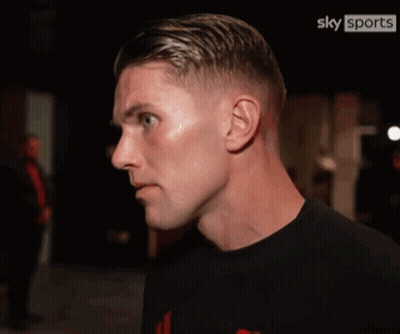 Two Minions Standing On City Street GIF