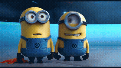 Two Minions Standing Together One In Overalls With Circle GIF