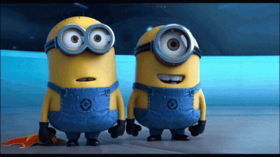 Two Minions Standing Together One With C Overalls GIF