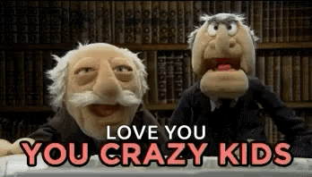 Two Muppets Are Sitting Next To Each Other In A Library . GIF