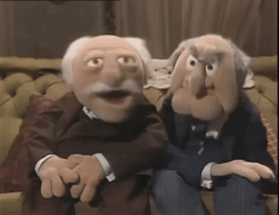 Two Muppets Are Sitting Next To Each Other On A Couch In A Living Room . GIF